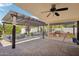 Expansive backyard with shaded seating areas, a built-in grill, and manicured landscaping at 4920 E Osborn Rd, Phoenix, AZ 85018