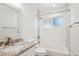 Updated bathroom features granite countertop, and tub with tiled backsplash at 4920 E Osborn Rd, Phoenix, AZ 85018
