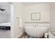 Tranquil bathroom featuring a modern soaking tub, granite countertops, and neutral decor, adjacent to the main bedroom at 4920 E Osborn Rd, Phoenix, AZ 85018