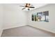 Bright bedroom with natural light pouring through the window, featuring neutral carpeting and white walls at 4920 E Osborn Rd, Phoenix, AZ 85018