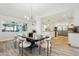 Open concept dining area with modern lighting flowing into kitchen with white cabinets and stainless appliances at 4920 E Osborn Rd, Phoenix, AZ 85018