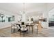 Bright dining area with stylish lighting, an open floor plan with modern kitchen and stainless steel appliances at 4920 E Osborn Rd, Phoenix, AZ 85018