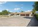 Spacious single-story home featuring a well-manicured front yard, a three-car garage, and a charming front porch at 4920 E Osborn Rd, Phoenix, AZ 85018