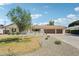 Inviting single-story home with a manicured front yard, gravel, and a convenient three-car garage at 4920 E Osborn Rd, Phoenix, AZ 85018
