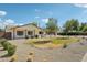 Charming single-story home with a beautifully landscaped front yard, gravel, and a well-maintained lawn at 4920 E Osborn Rd, Phoenix, AZ 85018
