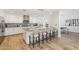 Bright kitchen boasts a large island with seating, stylish light fixtures, and stainless steel appliances at 4920 E Osborn Rd, Phoenix, AZ 85018