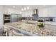 Gourmet kitchen featuring a large island with seating, granite countertops, and stainless steel appliances at 4920 E Osborn Rd, Phoenix, AZ 85018