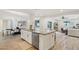 Modern kitchen featuring granite countertop island with dishwasher, and open access to the dining and living rooms at 4920 E Osborn Rd, Phoenix, AZ 85018
