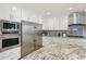 Bright kitchen featuring stainless steel appliances, granite countertops, tile backsplash, oven and built-in microwave at 4920 E Osborn Rd, Phoenix, AZ 85018