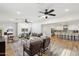Large living room with an open floor plan to the kitchen, ceiling fans, wood-look floors, and stylish decor at 4920 E Osborn Rd, Phoenix, AZ 85018