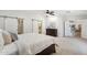 Relaxing main bedroom showcasing neutral carpeting, ceiling fan, ensuite bathroom, and walk-in closet with barn door access at 4920 E Osborn Rd, Phoenix, AZ 85018
