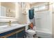 Modern bathroom featuring stylish blue vanity with a vessel sink and a shower-tub with a stylish shower curtain at 5612 S 21St Pl, Phoenix, AZ 85040
