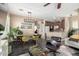 Open-concept dining area featuring a modern chandelier, wood table, and green chairs at 5612 S 21St Pl, Phoenix, AZ 85040
