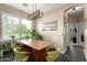 Comfortable dining area with a wooden table, stylish chairs, and a modern light fixture at 5612 S 21St Pl, Phoenix, AZ 85040