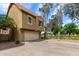 Tan two-story townhouse with a front-facing garage and desert landscaping surrounding the property at 5612 S 21St Pl, Phoenix, AZ 85040