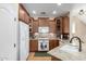 Inviting kitchen featuring wood cabinets, granite countertops, and modern appliances at 5612 S 21St Pl, Phoenix, AZ 85040