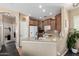 Well-lit kitchen with granite counters, wood cabinets and a view to the living area at 5612 S 21St Pl, Phoenix, AZ 85040