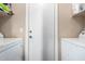 Laundry room featuring side-by-side washer and dryer units and a white door at 5612 S 21St Pl, Phoenix, AZ 85040