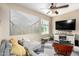 Cozy living room features a large wall art, a ceiling fan, and comfortable seating at 5612 S 21St Pl, Phoenix, AZ 85040