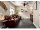 Cozy living room featuring a comfortable leather sofa, and modern tile flooring at 5612 S 21St Pl, Phoenix, AZ 85040
