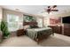 Spacious main bedroom with large windows, a ceiling fan, and a king-sized bed at 5612 S 21St Pl, Phoenix, AZ 85040