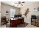 Office with desk, chair, computer, ceiling fan, and mounted animal hide at 5612 S 21St Pl, Phoenix, AZ 85040