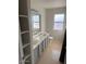 Bathroom featuring a double sink vanity, window, toilet, and built in shelving at 60 S Willow Creek St, Chandler, AZ 85225