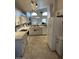 Open kitchen with white cabinetry, stainless steel appliances, and granite countertops at 60 S Willow Creek St, Chandler, AZ 85225