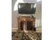 Cozy living room with a brick fireplace and large screen TV at 60 S Willow Creek St, Chandler, AZ 85225