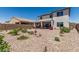 Spacious backyard featuring desert landscaping, a covered patio, and vibrant flowering plants and privacy fence at 6305 W Pleasant Oak Ct, Florence, AZ 85132