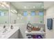 Spacious bathroom with large mirror, vanity, and walk-in shower with tiled walls and glass partition at 6305 W Pleasant Oak Ct, Florence, AZ 85132