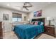 Cozy bedroom features a desk and chair by the window and a comfortable bed with decorative pillows at 6305 W Pleasant Oak Ct, Florence, AZ 85132