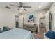 Comfortable bedroom features a ceiling fan, carpet floors, walk-in closet, and a stylish desk at 6305 W Pleasant Oak Ct, Florence, AZ 85132