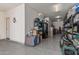 Spacious garage with epoxy floors and ample storage space with multiple metal shelving units and organized household items at 6305 W Pleasant Oak Ct, Florence, AZ 85132