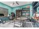 Well-lit home office with teal walls, wood-look floors, decorative shelving and ceiling fan at 6305 W Pleasant Oak Ct, Florence, AZ 85132