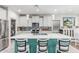 Modern kitchen with a large island with seating, pendant lights, and a mosaic tile backsplash at 6305 W Pleasant Oak Ct, Florence, AZ 85132