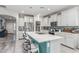 Modern kitchen with white cabinets, a large island with bar stools, and stainless steel appliances at 6305 W Pleasant Oak Ct, Florence, AZ 85132