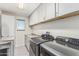 Bright laundry room with granite counters, modern Samsung washer and dryer and updated cabinets for ample storage at 6305 W Pleasant Oak Ct, Florence, AZ 85132