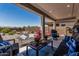 Covered patio area with comfortable seating and views of the beautifully landscaped backyard at 6305 W Pleasant Oak Ct, Florence, AZ 85132
