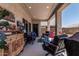 Inviting covered patio with an outdoor seating area and stylish decor overlooking the backyard at 6305 W Pleasant Oak Ct, Florence, AZ 85132