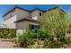 This well-maintained yard features desert landscaping with lush green shrubs and trees at 6305 W Pleasant Oak Ct, Florence, AZ 85132
