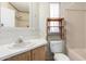 Traditional bathroom featuring floral wallpaper, toilet, bathtub and vanity with wooden cabinets at 6391 S Oakmont Dr, Chandler, AZ 85249