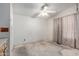 Spacious bedroom featuring natural light, a ceiling fan, and basic finishes at 6391 S Oakmont Dr, Chandler, AZ 85249