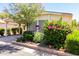 Well-maintained single-story home with a landscaped front yard boasting colorful bushes and green plants at 6391 S Oakmont Dr, Chandler, AZ 85249