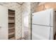 Walk-in pantry and a white refrigerator with outdated cabinets at 6391 S Oakmont Dr, Chandler, AZ 85249