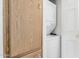 This laundry area features a stacked washer and dryer with adjacent wood storage cabinet at 6391 S Oakmont Dr, Chandler, AZ 85249