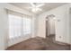 Cozy living room featuring carpet flooring, a large window, and access to other rooms at 6391 S Oakmont Dr, Chandler, AZ 85249