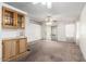 Open living space with built in cabinets, carpet flooring, and a sliding glass door at 6391 S Oakmont Dr, Chandler, AZ 85249