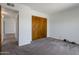 Bedroom with an open doorway to a room and a wood closet door at 7530 E North Ln, Scottsdale, AZ 85258
