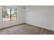 Carpeted bedroom with a large window overlooking the neighborhood at 7530 E North Ln, Scottsdale, AZ 85258